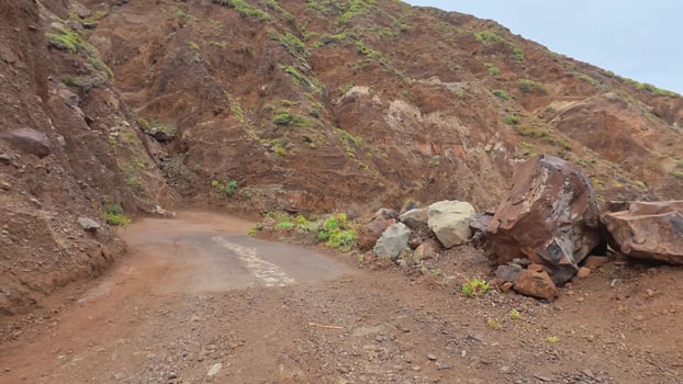 Explore a scenic and beautiful unpaved mountain road that is surrounded by rocky terrain and lush greenery photo