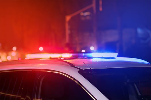 Blue and red lights on top of police car at night city in street photo