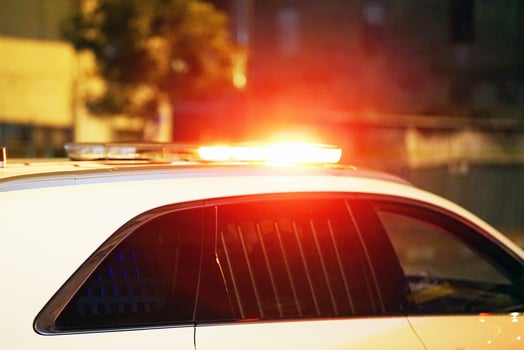 Red lights on top of police car in street photo