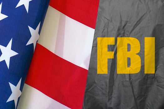The inscription on the FBI jacket and Flag of America photo