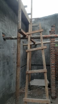 Wooden Ladder and Bamboo Scaffolding at Construction Site photo