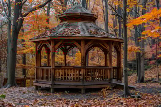 Wooden gazebo standing in a forest during peak fall foliage photo