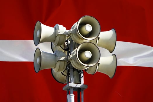 Flag of Latvia. Loudspeaker on Latvia flag background photo