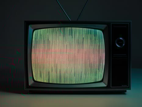 Vintage television displaying colorful static in a dark setting, evoking nostalgia and retro charm. photo