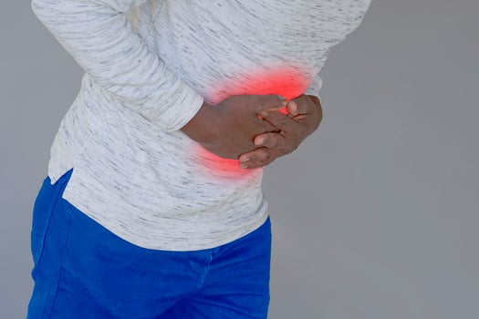 Afro man suffering from stomach. African american man suffering from gastritis, touching tummy photo
