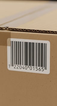 Barcode sticker with black lines and numbers on a brown corrugated cardboard box for shipping. photo