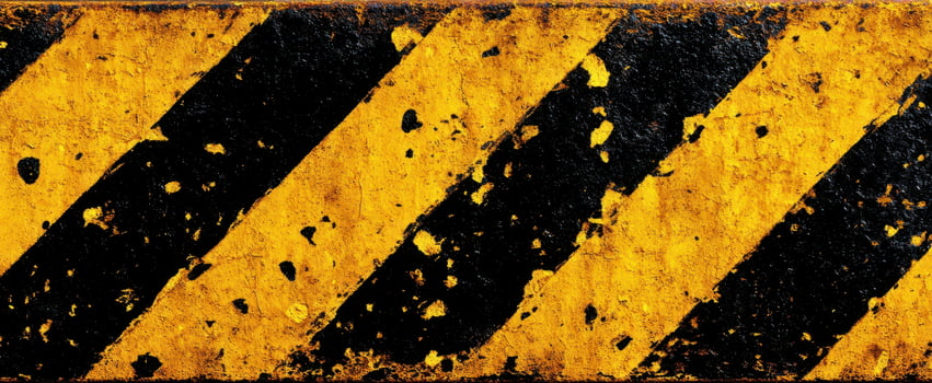 The warning stripes signaling caution on a weathered surface. photo
