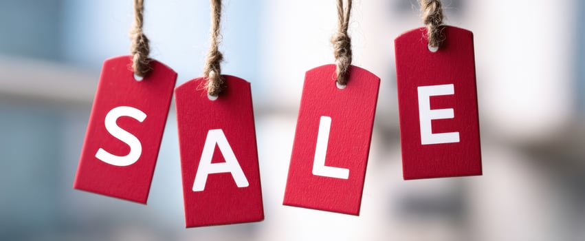 The vibrant red sale tags hanging to entice shoppers and promote discounts photo