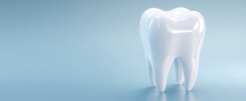 The Glossy White Tooth on a Soft Blue Background photo