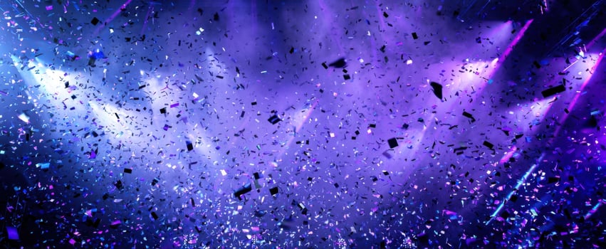 The colorful confetti falling under bright stage lights at a vibrant celebration. photo