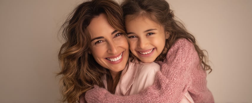 The joyful moment of a mother and daughter sharing a warm embrace. photo