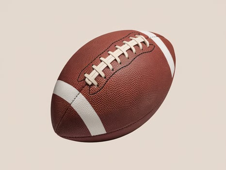 A close-up of an American football with textured leather and white stripes against a light background. photo