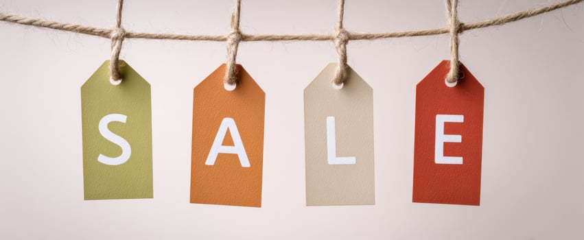 The colorful sale tags hanging on a rope for promotional purposes photo