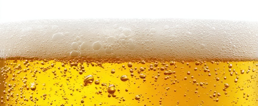 The refreshing golden beer topped with frothy bubbles and rich texture. photo