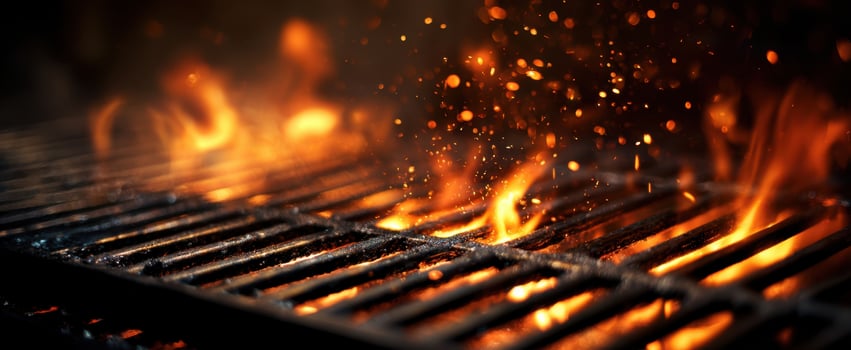 The vibrant flames dancing over a sizzling barbecue grill at twilight. photo