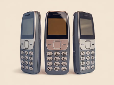Three vintage mobile phones arranged neatly, showcasing classic design and simplicity. photo