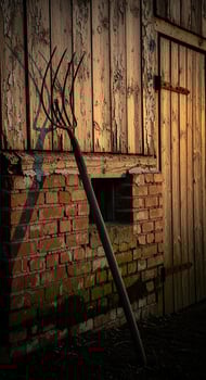 Rustic Barn with Old Pitchfork at Sunset photo