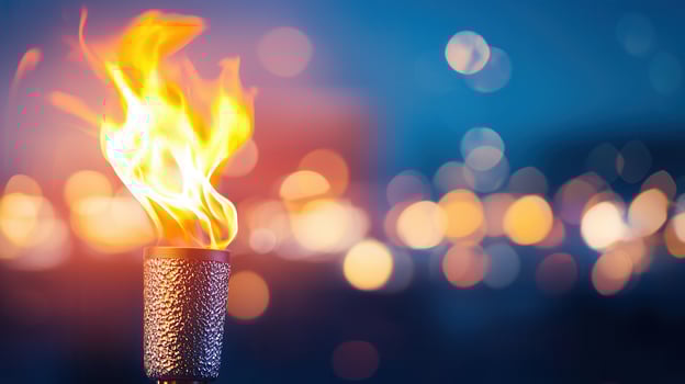 Burning torch with blurred city lights in background during a colorful sunset, creating a evocative and dramatic scene photo