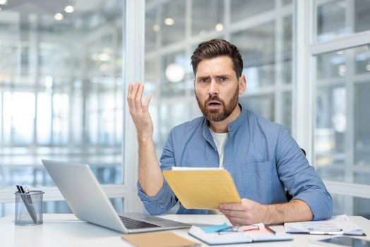 Man surprised by reports in office photo