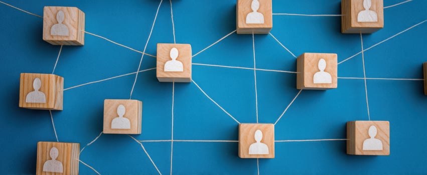The connected network diagram of wooden blocks representing people and relationships. photo