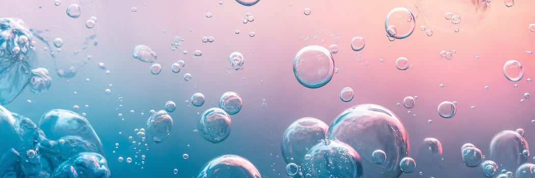 Colorful bubbles float in a soft gradient of pink and blue, creating a serene underwater atmosphere. photo