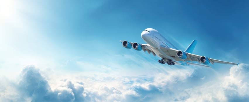 The airplane soaring through bright blue skies above fluffy white clouds. photo