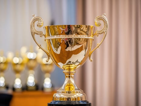 A gleaming gold trophy stands proudly on a display, symbolizing achievement and victory. photo