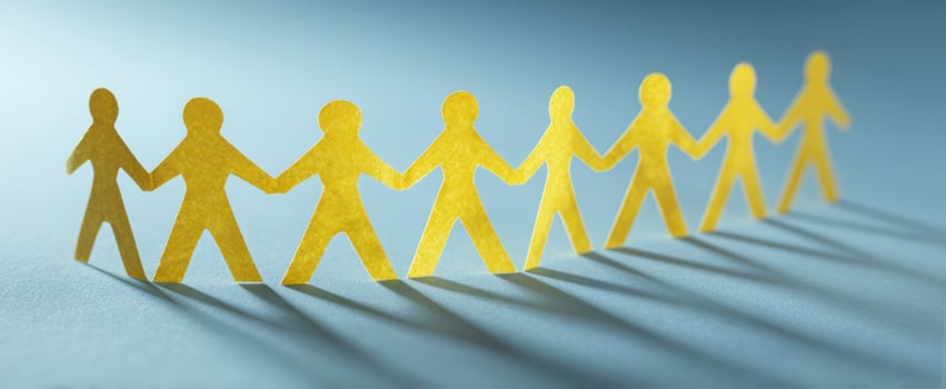 The vibrant paper cutout people symbolize unity and collaboration in teamwork. photo
