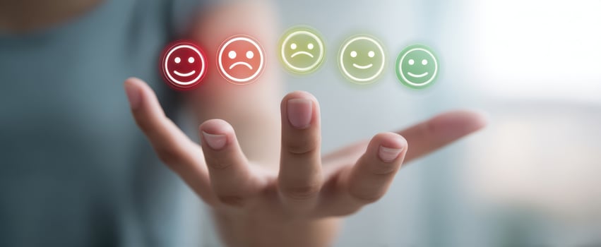 The hand displaying a range of emotional feedback icons for assessment photo