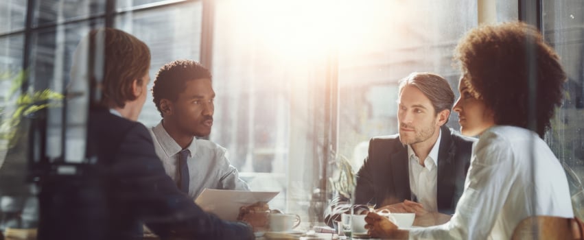 The group of professionals engaged in a collaborative business meeting with a bright atmosphere. photo