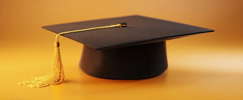 The elegant black graduation cap with golden tassel on golden background. photo