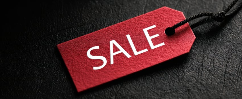 The striking red sale tag on a sleek black background. photo