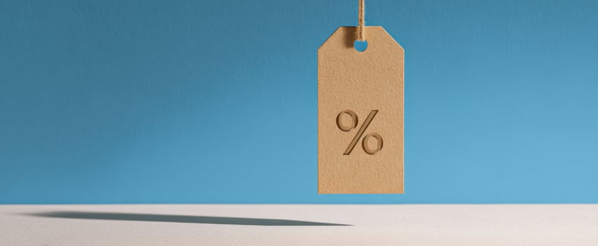 The percentage tag hanging against a vibrant blue background, showcasing discounts. photo