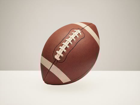 A close-up of an American football on a neutral background, showcasing its textured surface and laces. photo