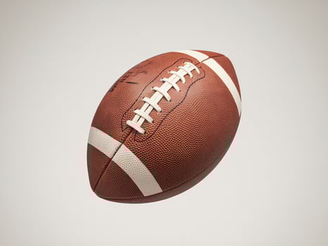 Close-up of a classic brown football with white lace details, set against a neutral background. photo