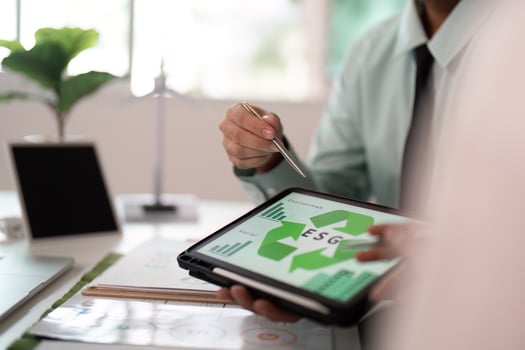 ESG data analysis in office with tablet and charts photo