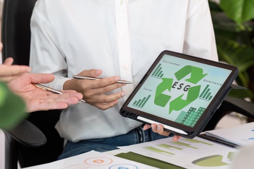 ESG Presentation. Business Professionals Analyzing Environmental Strategies with Digital Tools. photo