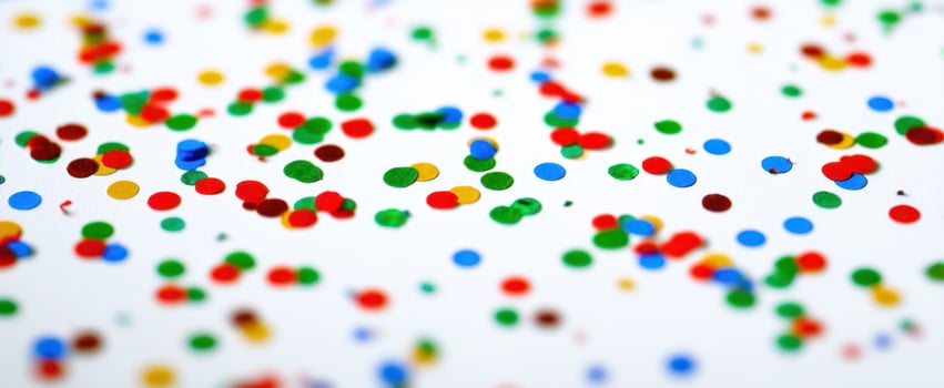 The colorful confetti scattered joyfully across a bright white background. photo