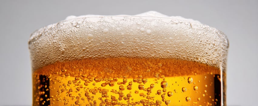 The refreshing beer with bubbles and foam in a glass, perfect for any occasion. photo