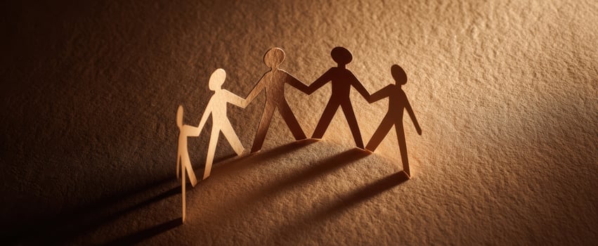 The paper figures symbolize unity and connection among diverse individuals. photo