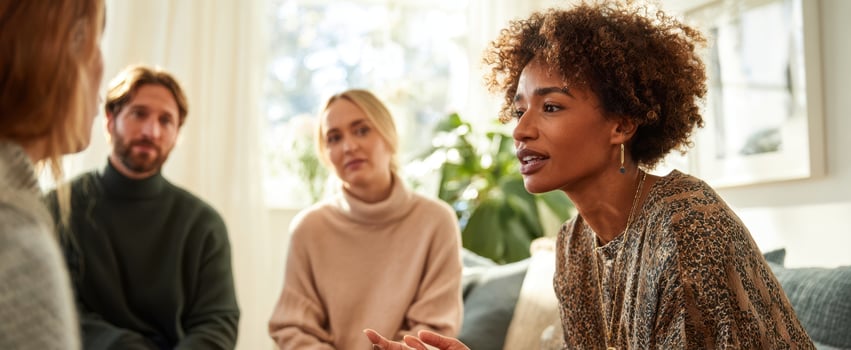 The engaged woman leading a thoughtful conversation in a cozy group setting photo