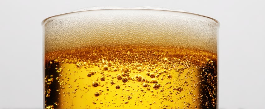 The refreshing frothy beer bubbling in a glass ready to enjoy. photo