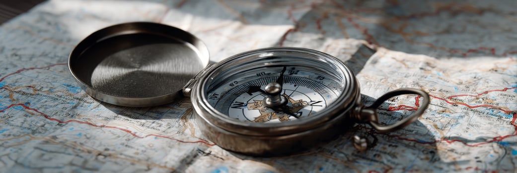 Vintage Compass on Old Map Symbolizing Exploration, Adventure, and Navigation in a Natural Setting photo