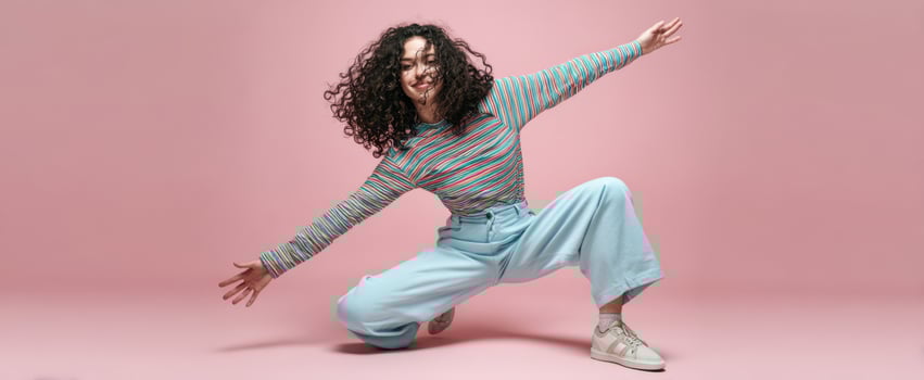 The confident model showcasing vibrant fashion in a playful pose against a pastel background. photo