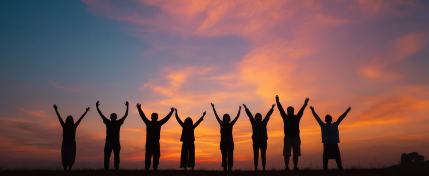 The silhouette of a group celebrating a beautiful sunset in harmony. photo