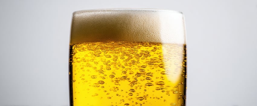 The refreshing golden beer served in a frosty glass with bubbles. photo