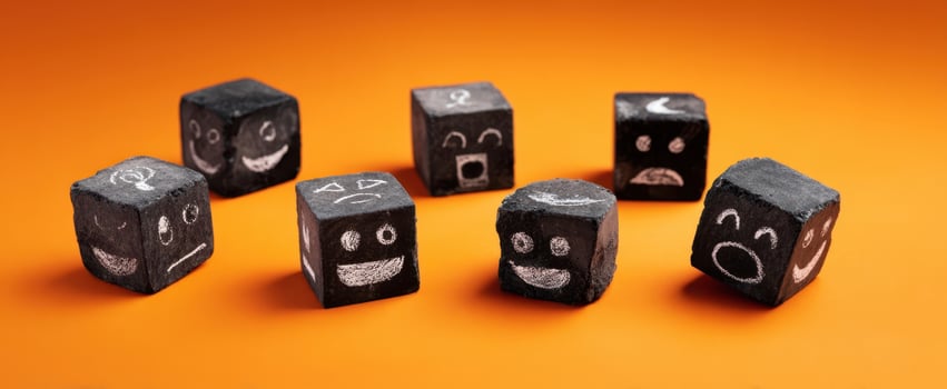 The cheerful black blocks with quirky faces on an orange background. photo