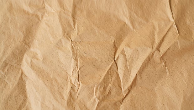 Close up of crumpled brown paper texture and folds photo