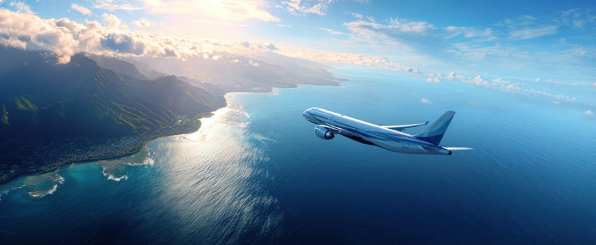 The airplane soaring above a stunning coastal landscape at sunset. photo