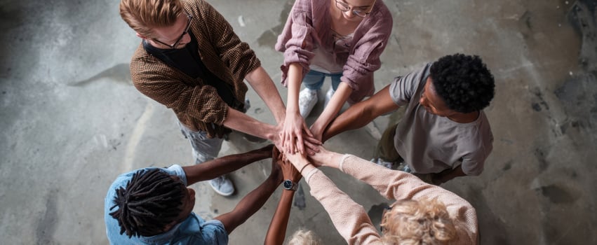 The group of diverse individuals uniting hands in a show of teamwork and collaboration. photo